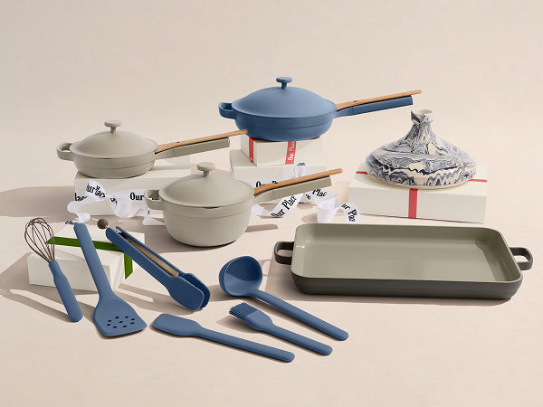 Set of kitchen utensils and cookware with blue and gray colors on a beige background